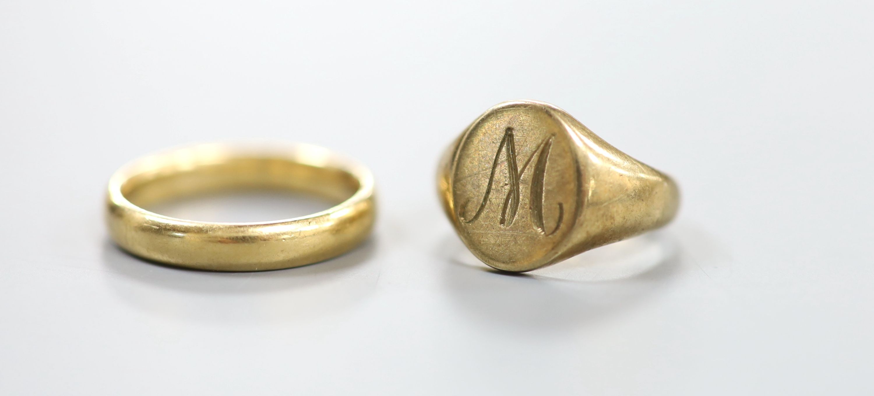 A 9ct gold signet ring, size E, 4.4 grams and an 18ct wedding band, 4 grams.